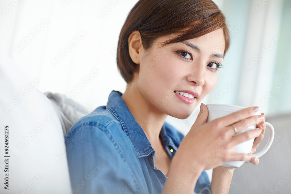 Asian woman, portrait and coffee in house to relax, peace and comfortable at weekend break on sofa. Female person, face and latte in living room on couch for wellbeing, self care or rest on day off Asian woman, portrait and coffee in house to relax, peace and comfortable at weekend break on sofa. Female person, face and latte in living room on couch for wellbeing, self care or rest on day off