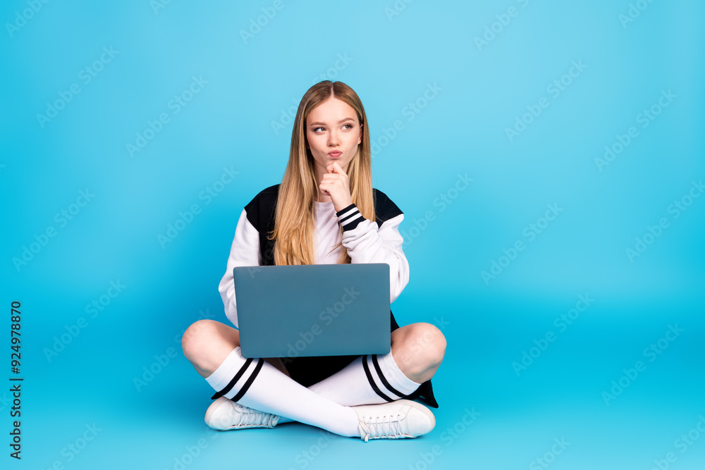 Photo of cute lovely adorable dreamy girl wear trendy clothes hand chin hmm decision empty space solated on blue color background Photo of cute lovely adorable dreamy girl wear trendy clothes hand chin hmm decision empty space solated on blue color background