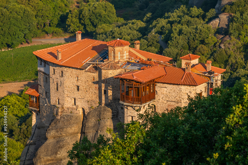 Monasteries located on unique rock formations in the Meteora region of Greece are illuminated by the sunrise light. Monasteries located on unique rock formations in the Meteora region of Greece are illuminated by the sunrise light.
