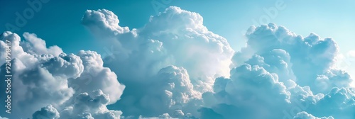 Large, fluffy white clouds float against a backdrop of vibrant blue sky, capturing a moment of natural splendor and tranquility. photo