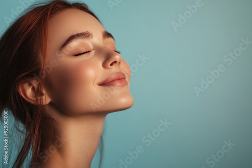 A close up of a woman's face with tattoos and her eyes closed