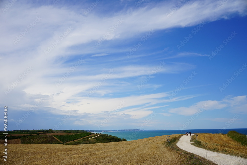 People walking on the road in the natural reserve of Punta Aderci, Abruzzo, Italy People walking on the road in the natural reserve of Punta Aderci, Abruzzo, Italy