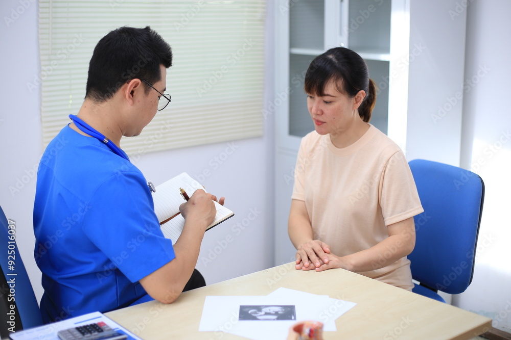 Fototapeta premium Male doctor with experience examining young pregnant women