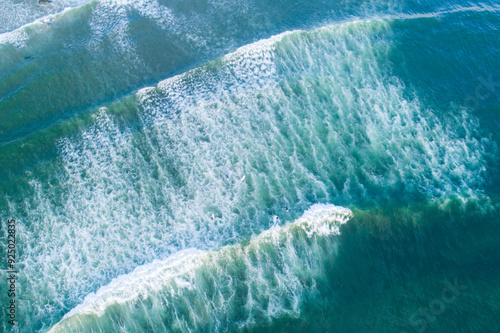Ocean waves and surfboards: aerial surfing scene. Drone zenithal photography, summer sport concept. Holidays background