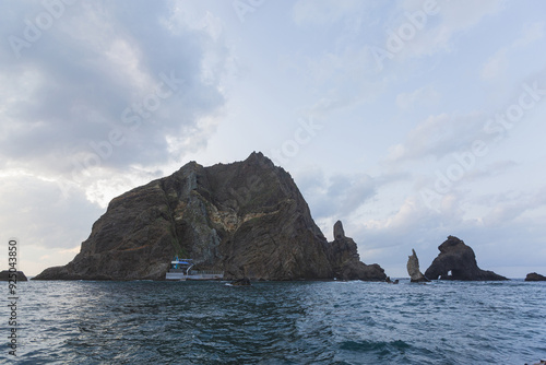 Ulleung-gun, Gyeongsangbuk-do, South Korea - October 26, 2019: Summer view of Dokdo Island on the sea with Candlestick Rock and Three Brothers Cave Rock photo