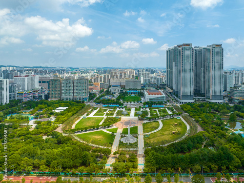 Jung-dong, Bucheon-si, Gyeonggi-do, South Korea - July 2, 2022: Aerial view of Bucheon Central Park and Bucheon City Hall with apartments in summer photo