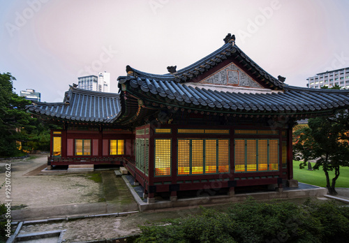 Jongno-gu, Seoul, South Korea - August 4, 2022: Night view of window door of a tiled house with illumination at Deoksugung Palace after sunset