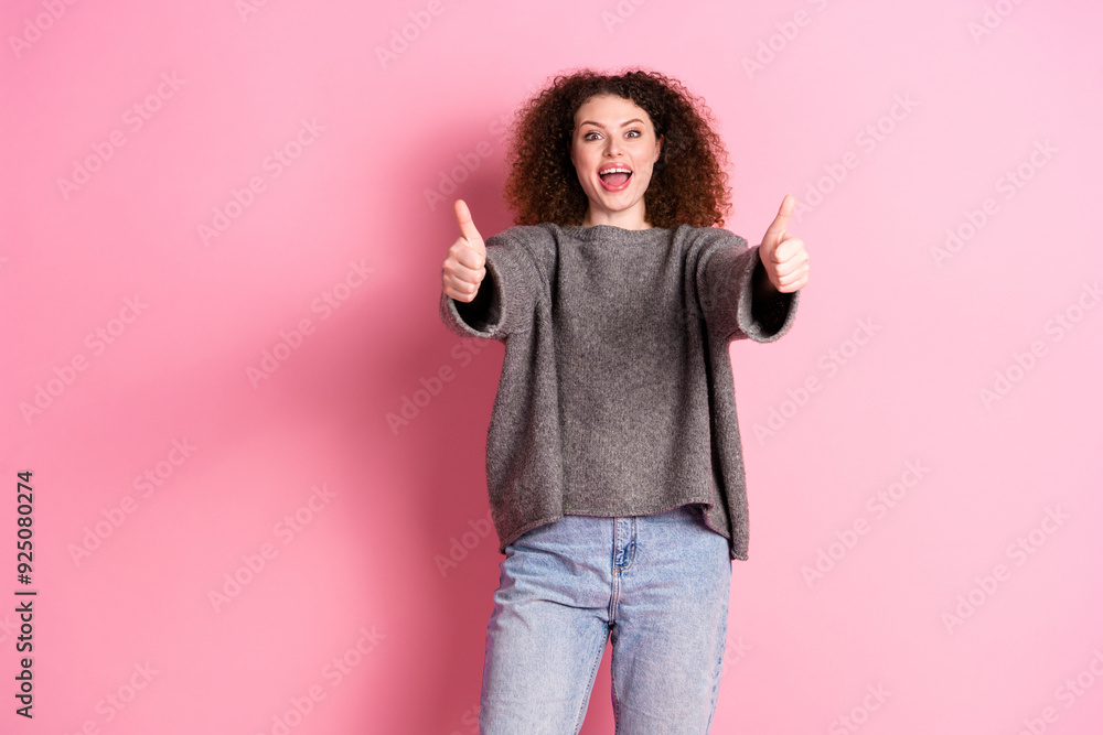 Photo portrait of attractive young woman excited show thumb up dressed stylish gray clothes isolated on pink color background Photo portrait of attractive young woman excited show thumb up dressed stylish gray clothes isolated on pink color background