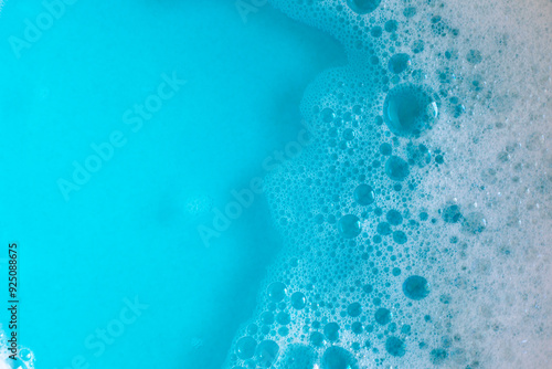 Foam in blue water. Blue foam. Water with foam bubbles. Blue background