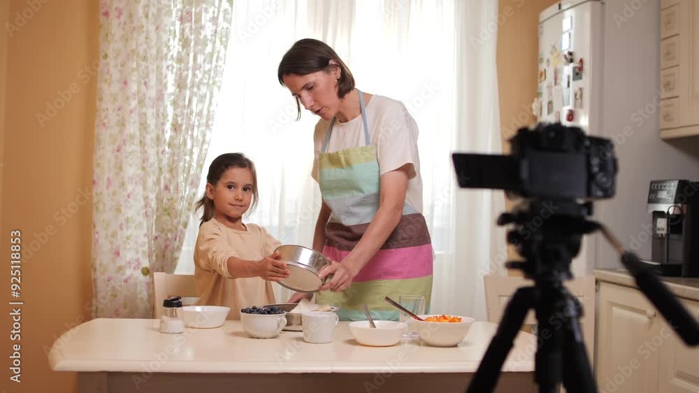 Mother and daughter baking together in cozy home kitchen Mother and daughter baking together in cozy home kitchen
