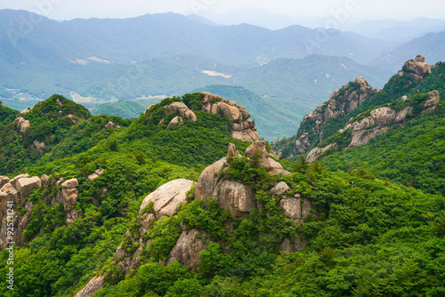 High angle and summer view of rocks and cliff of Munjangdae Peak at Songnisan National Park near Sangju-si, South Korea photo