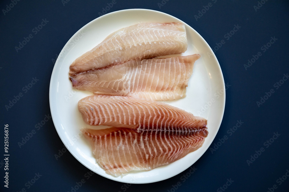Fillet of tilapia or Saint Peter fish Oreochromis niloticus. Isolated on white background Fillet of tilapia or Saint Peter fish Oreochromis niloticus. Isolated on white background