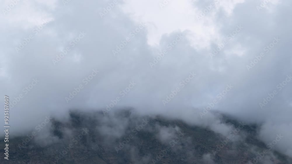 4K Time-lapse shot of dark monsoon stormy clouds above the Himalayan mountain peak as seen from Keylong in Lahaul, Himachal Pradesh, India. Clouds move above the mountains during monsoon. 4K Time-lapse shot of dark monsoon stormy clouds above the Himalayan mountain peak as seen from Keylong in Lahaul, Himachal Pradesh, India. Clouds move above the mountains during monsoon.