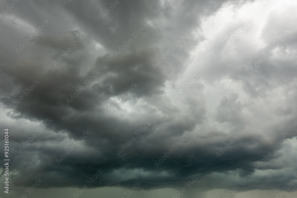 Huge dark cumulus bad weather storm clouds with visible rainfall Huge dark cumulus bad weather storm clouds with visible rainfall