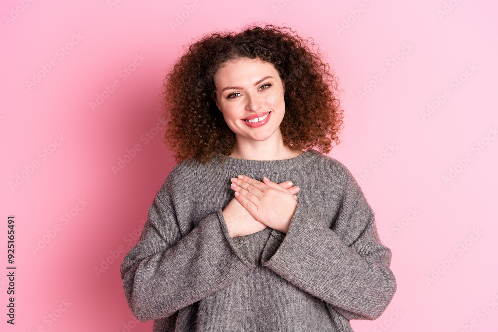 Photo portrait of lovely young lady touch chest grateful dressed stylish gray garment isolated on pink color background Photo portrait of lovely young lady touch chest grateful dressed stylish gray garment isolated on pink color background