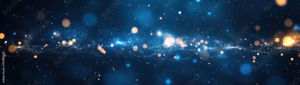 Obraz premium Abstract blue and gold bokeh background with glittering particles, perfect for festive and celebration themes, adding a touch of magic and wonder.