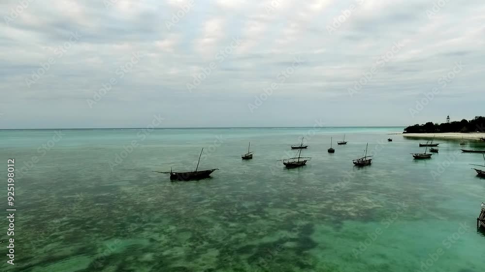 Fishing Wooden Boats Floating In Shallow Water Of Coast Line Of Zanzibar Fishing Wooden Boats Floating In Shallow Water Of Coast Line Of Zanzibar