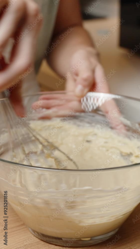 Vertical video. Whisking a Thick Batter in a Glass Bowl, Preparing for the Next Baking Step. Vertical video. Whisking a Thick Batter in a Glass Bowl, Preparing for the Next Baking Step.