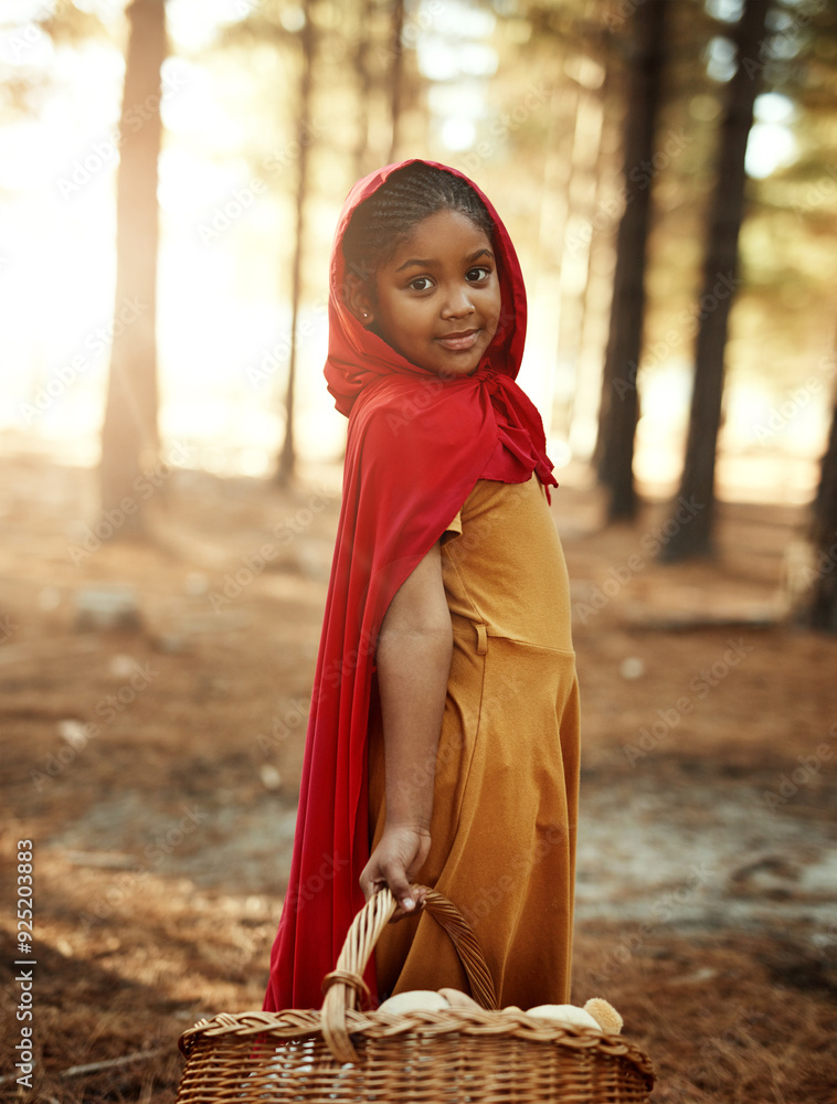 Kid, red and basket in forest for portrait, adventure and fairytale fantasy in nature. Girl, hamper and hood in woods for story themed birthday party, magic and cosplay at trees with creativity Kid, red and basket in forest for portrait, adventure and fairytale fantasy in nature. Girl, hamper and hood in woods for story themed birthday party, magic and cosplay at trees with creativity