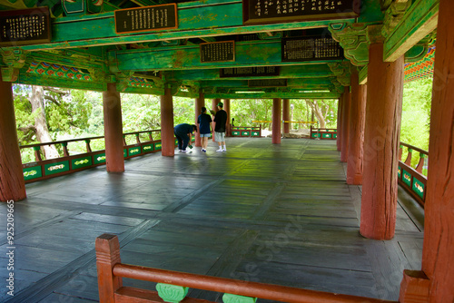 Visitors Inside Jukseoru Pavilion Observing Traditional Wooden Architecture in Samcheok photo