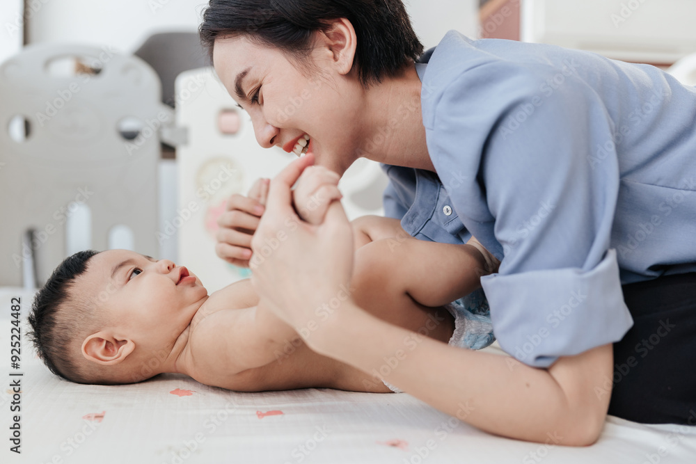 Asian adorable baby shirtless in a good mood, Enjoy playing with mother. Mother day concept. Asian adorable baby shirtless in a good mood, Enjoy playing with mother. Mother day concept.