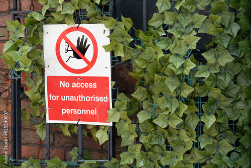 No access sign with gate and leafy bush photo