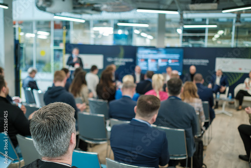 Professionals attending a business conference, focusing on presentations and networking in a modern setting. Engaging discussions and collaboration.