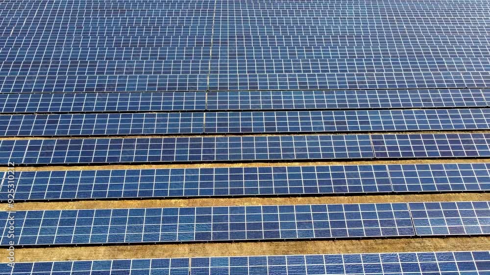 Aerial drone view flight over solar power station panels. Aerial top view of solar farm. Green energy, electrical innovation. Renewable Energy. Industrial Solar Energy Farm producing solar power. Aerial drone view flight over solar power station panels. Aerial top view of solar farm. Green energy, electrical innovation. Renewable Energy. Industrial Solar Energy Farm producing solar power.