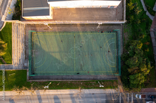 Aerial drone top view of mini football soccer field. Public sport ground in city at sunny summer day drone view photo