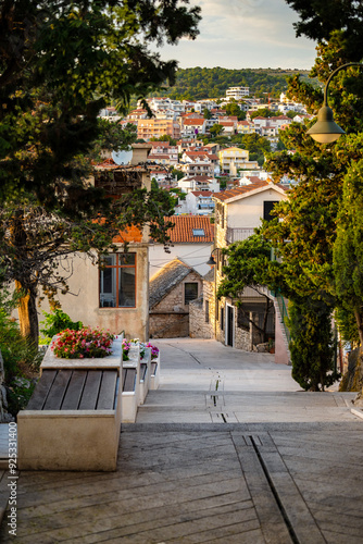 Beautiful, narrow, stone streets and old houses of famous tourist town of Primosten, Croatia at sunset