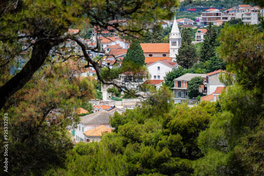 View from the pine tree forest on small, dalmatian houses and Church of the Assumption of the Blessed Virgin Mary at Rogoznica, Croatia View from the pine tree forest on small, dalmatian houses and Church of the Assumption of the Blessed Virgin Mary at Rogoznica, Croatia