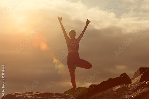 Wallpaper Mural woman doing a tree pose yoga position outdoors on rocks at sunrise, sunset. Torontodigital.ca