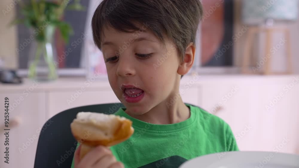Young boy enjoying a snack, showing a playful and joyful expression. happiness of childhood during a relaxed time at home Young boy enjoying a snack, showing a playful and joyful expression. happiness of childhood during a relaxed time at home