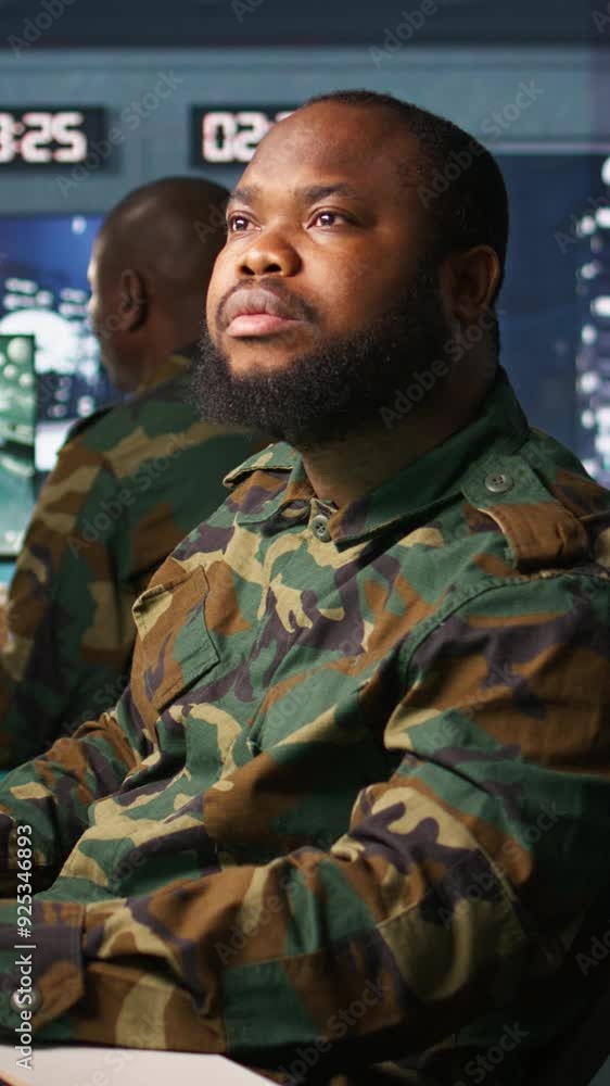 Vertical video Officer doing tasks in military base, planning, analyzing and gathering information on enemy troops. Agent in base of operations doing assessment of enemy vulnerabilities, tracking Vertical video Officer doing tasks in military base, planning, analyzing and gathering information on enemy troops. Agent in base of operations doing assessment of enemy vulnerabilities, tracking