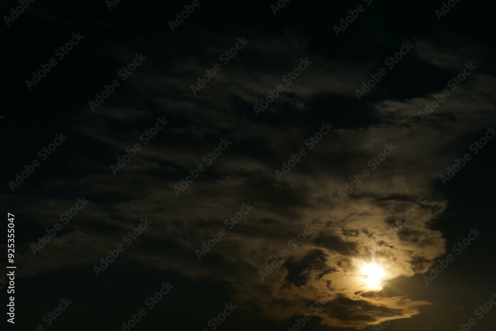 Sun covered by clouds at dusk. The sky seems like a work of art imbued with mystery, sadness and coldness. Sun covered by clouds at dusk. The sky seems like a work of art imbued with mystery, sadness and coldness.