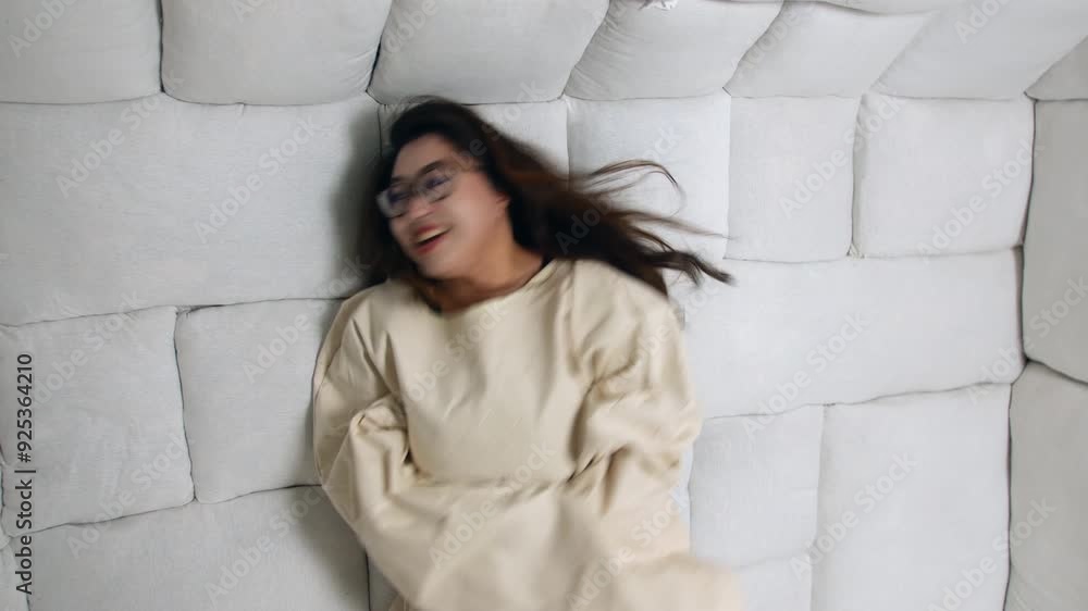 Crazy woman in a straitjacket thrashing on the floor of a padded room. Struggling within a confined cell in an insane asylum Crazy woman in a straitjacket thrashing on the floor of a padded room. Struggling within a confined cell in an insane asylum
