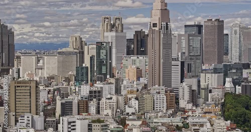 Tokyo Japan Aerial v210 zoomed flyover Sendagaya capturing downtown cityscape of Nishishinjuku Shinjuku city featuring Docomo tower on a partly cloudy day. - Shot with Mavic 3 Pro Cine - October 2023 photo