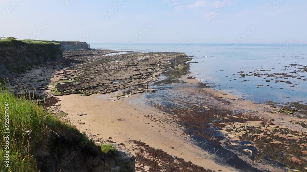 Panoramic View Of The Sea Coast At Low Tide In Calm Weather Panoramic View Of The Sea Coast At Low Tide In Calm Weather