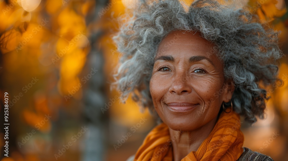 A middle-aged woman enjoys a peaceful walk outdoors during autumn, surrounded by colorful fall foliage. A middle-aged woman enjoys a peaceful walk outdoors during autumn, surrounded by colorful fall foliage.