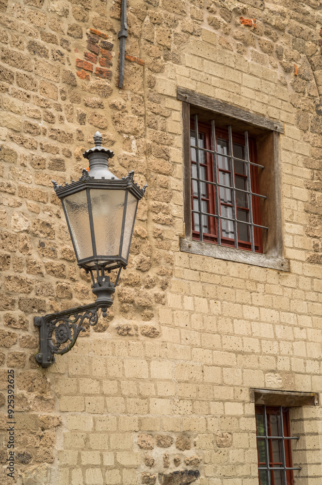 details of a medieval building, window and street lamp details of a medieval building, window and street lamp