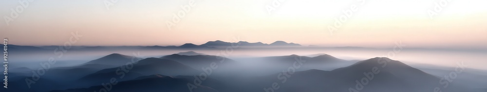 Evening fog envelops tranquil mountains at dusk Evening fog envelops tranquil mountains at dusk