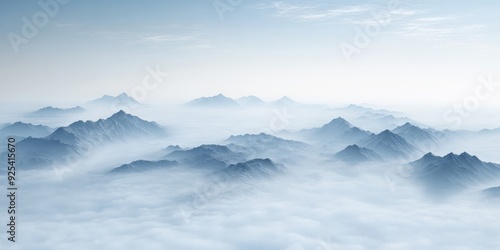 Fog-covered mountains at noon under a serene sky