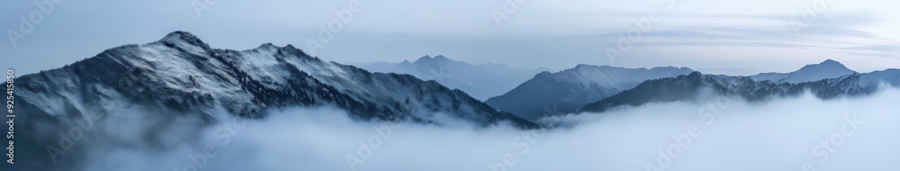Mountains enveloped in fog at noon in a serene landscape Mountains enveloped in fog at noon in a serene landscape