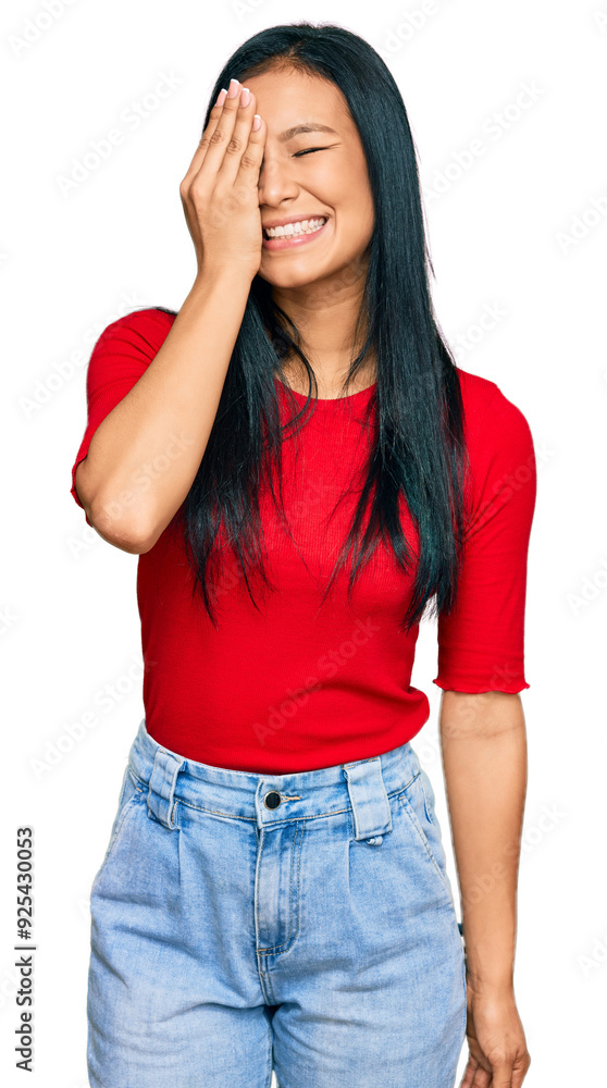 Beautiful hispanic woman wearing casual clothes covering one eye with hand, confident smile on face and surprise emotion. Beautiful hispanic woman wearing casual clothes covering one eye with hand, confident smile on face and surprise emotion.