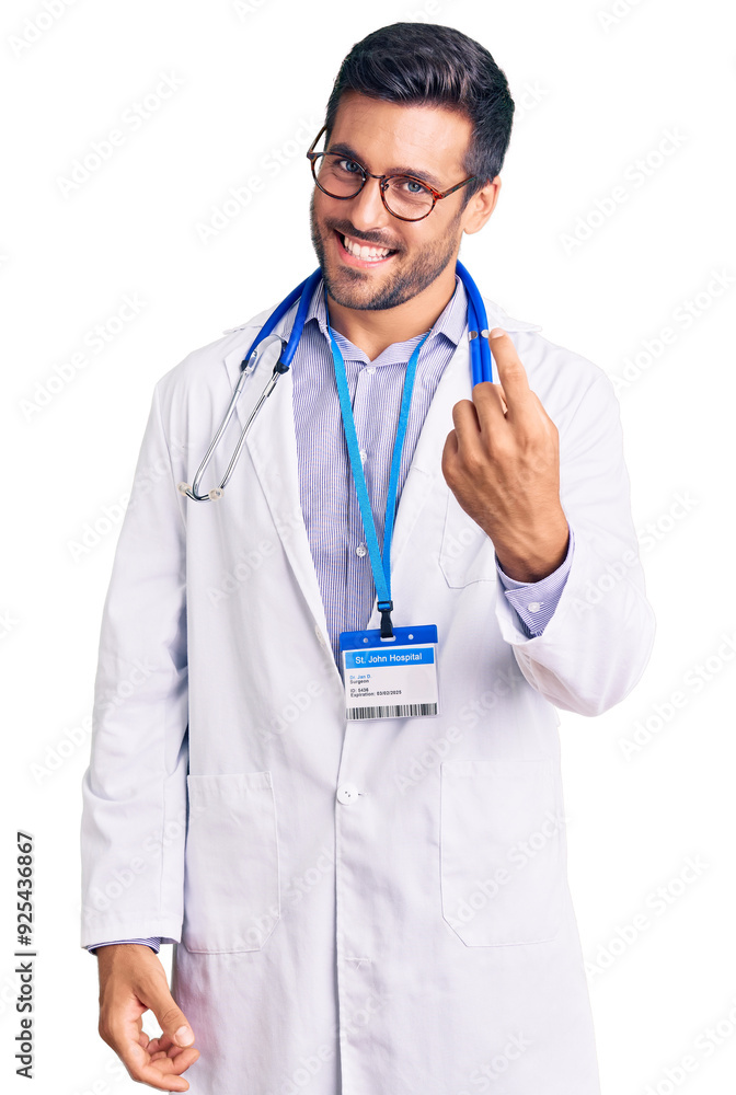 Young hispanic man wearing doctor uniform and stethoscope beckoning come here gesture with hand inviting welcoming happy and smiling Young hispanic man wearing doctor uniform and stethoscope beckoning come here gesture with hand inviting welcoming happy and smiling
