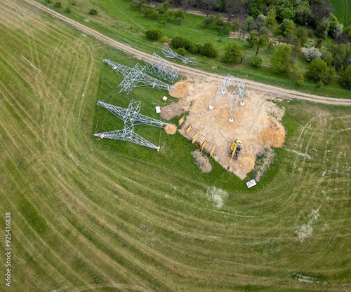 Electrical grid electricity network construction site inspection surveying, high voltage lines, overhead steel towers pylons, outdoors infrastructure engineering metal structure project