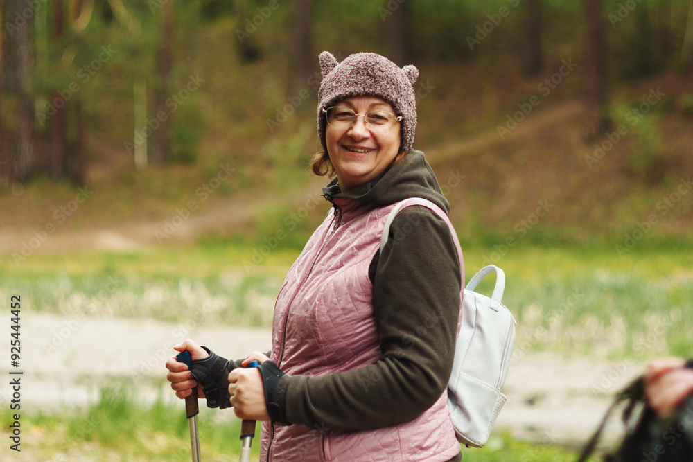 Woman hiking in a forest wearing a bear hat and enjoying the outdoors during springtime Woman hiking in a forest wearing a bear hat and enjoying the outdoors during springtime