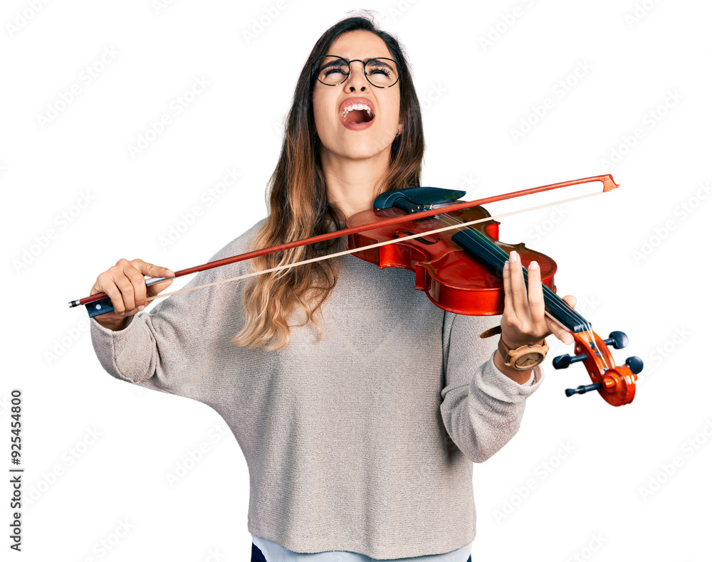 Beautiful hispanic woman playing violin angry and mad screaming frustrated and furious, shouting with anger looking up. Beautiful hispanic woman playing violin angry and mad screaming frustrated and furious, shouting with anger looking up.