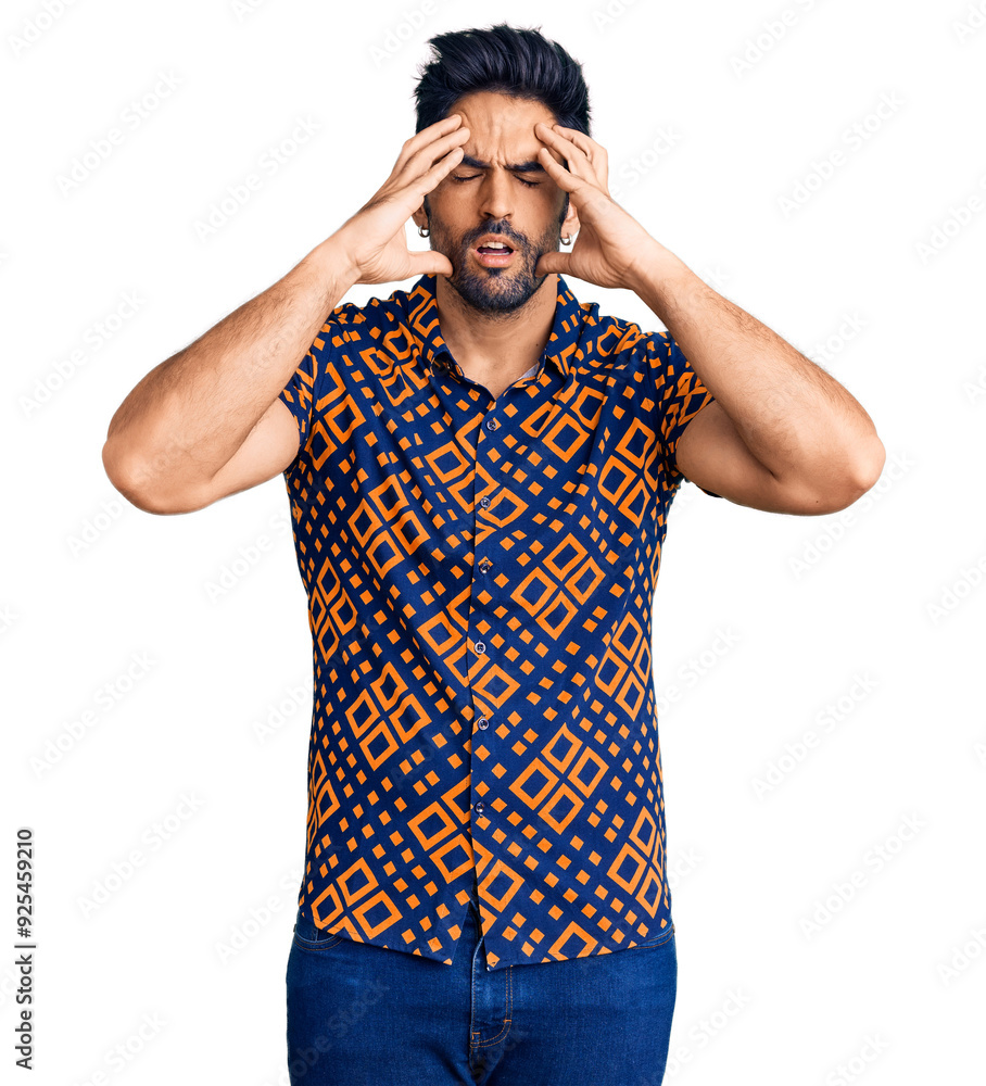 Handsome hispanic man wearing casual clothes suffering from headache desperate and stressed because pain and migraine. hands on head. Handsome hispanic man wearing casual clothes suffering from headache desperate and stressed because pain and migraine. hands on head.