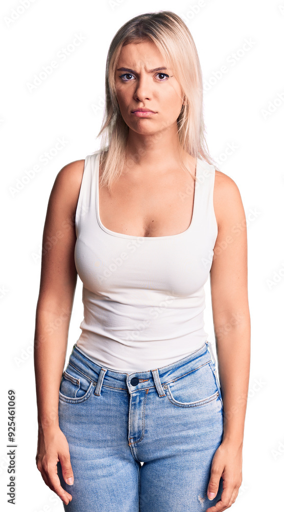 Young beautiful blonde woman wearing casual sleeveless t-shirt skeptic and nervous, frowning upset because of problem. negative person. Young beautiful blonde woman wearing casual sleeveless t-shirt skeptic and nervous, frowning upset because of problem. negative person.